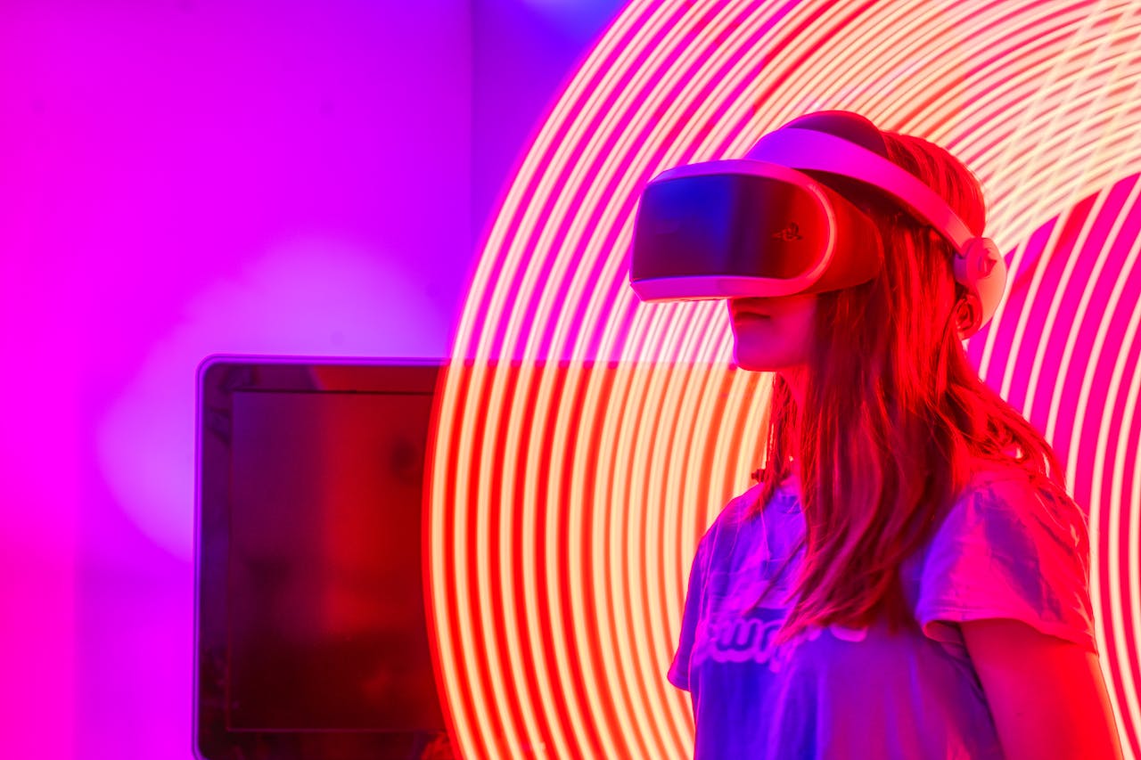 Initiatives A woman wearing VR glasses immersed in a neon-lit environment with swirling lights.