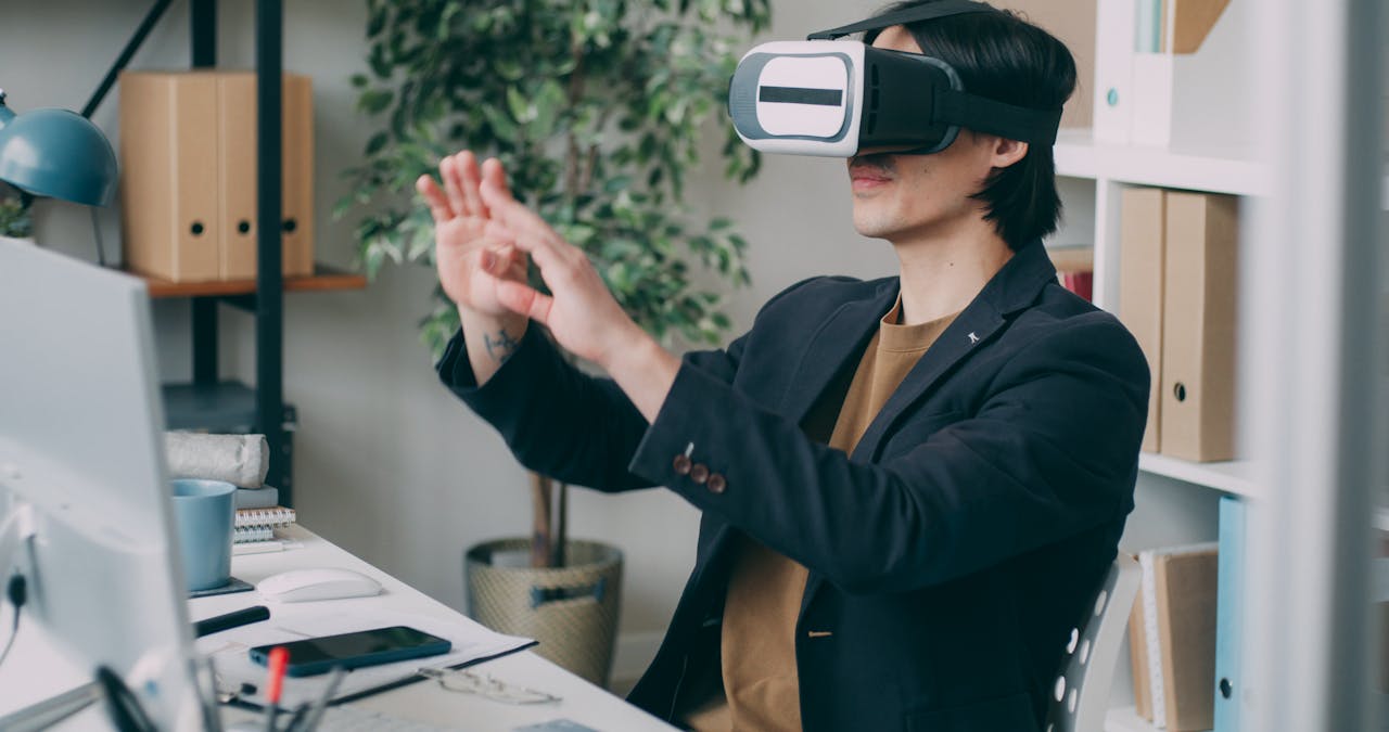 Initiatives A man in an office environment using a virtual reality headset, engaging with VR content.